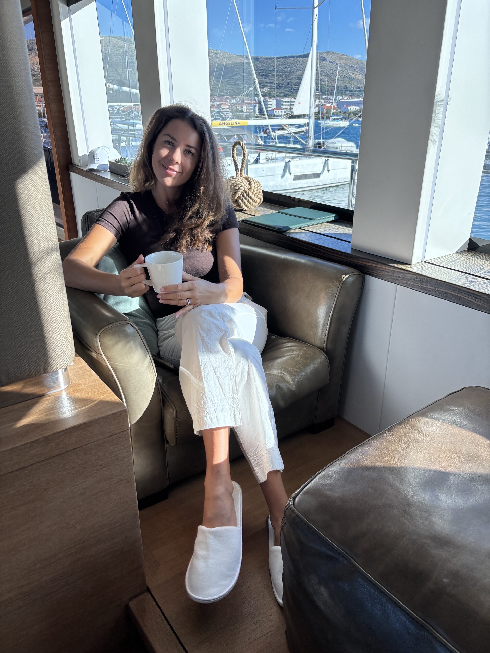 Coffee in the main salon, marina beyond the windows